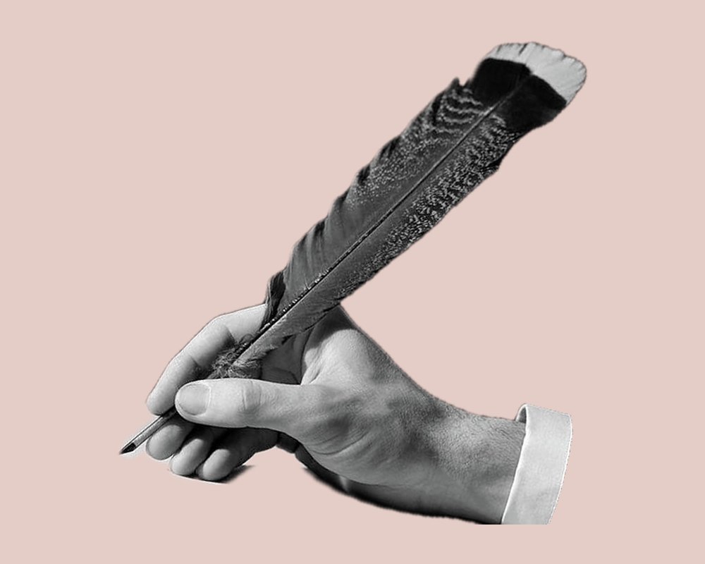 A hand holding a quill